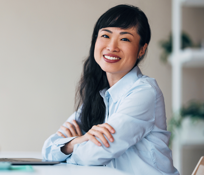 Woman at a desk in front of a laptop