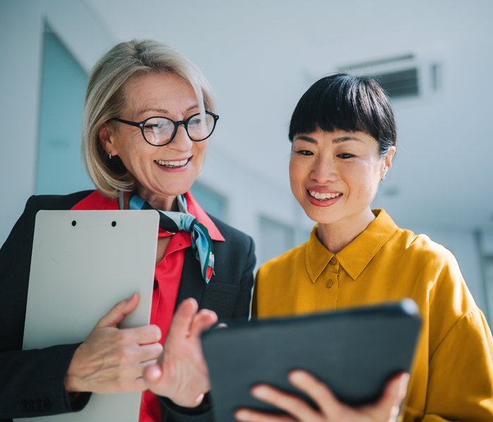 Two people looking at a tablet