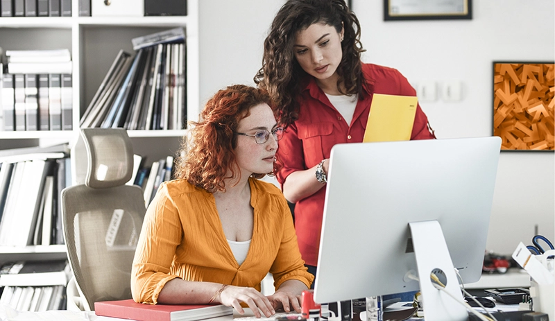 People talking at a computer