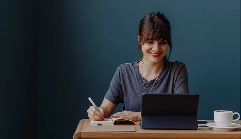 Woman writing on notepad